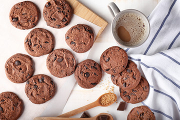 Tasty chocolate cookies and cup of coffee on light table