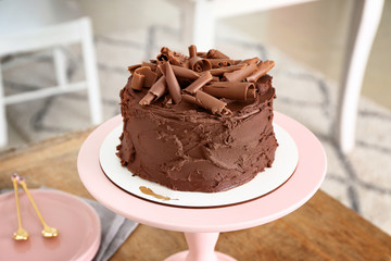 Tasty chocolate cake on stand