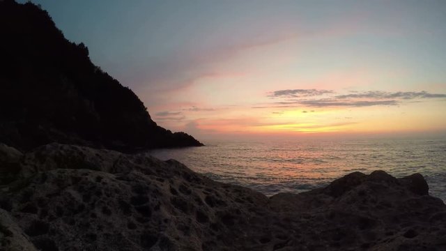 Beautiful cloudscape and sunset breaking through cloud over sea reflection, time lapse over water