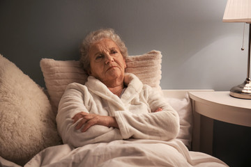 Senior woman suffering from insomnia at night - obrazy, fototapety, plakaty