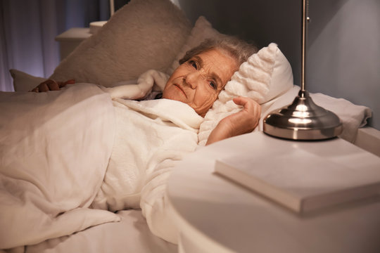 Senior Woman Suffering From Insomnia At Night