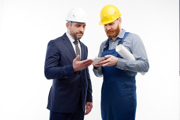 engineer and foreman look at the phone on a white background