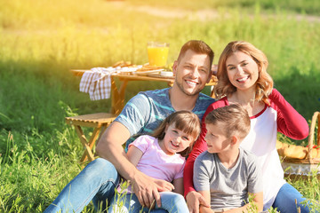 Naklejka na ściany i meble Happy family on summer picnic in park