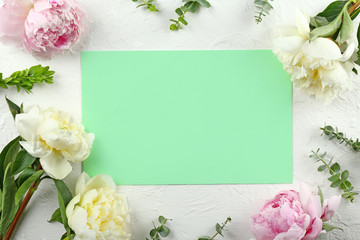 Obraz na płótnie Canvas Beautiful peony flowers and blank card on color background