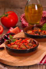 Marinated pork loin in tomato sauce.