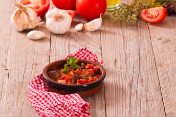Marinated pork loin in tomato sauce.