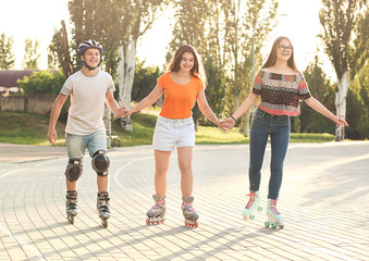 Teenagers on roller skates outdoors