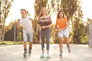 Obraz na płótnie Canvas Teenagers on roller skates outdoors