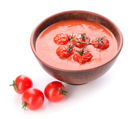 Bowl of tasty tomato cream soup on white background