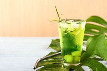 Glass of tasty summer cocktail on table
