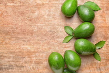 Fresh ripe avocados on wooden background