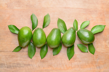 Fresh ripe avocados on wooden background