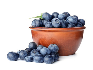Bowl with ripe blueberry on white background
