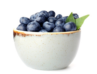 Bowl with ripe blueberry on white background