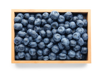Box with ripe blueberry on white background