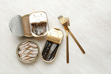 Tin cans with different food on light background