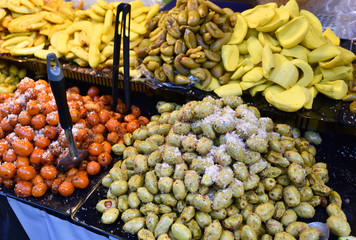 Asia fruit preserve on tray with star gooseberry, mango, Garcinia schomburgkiana pierre and jujube fruit for sale in street food thailand