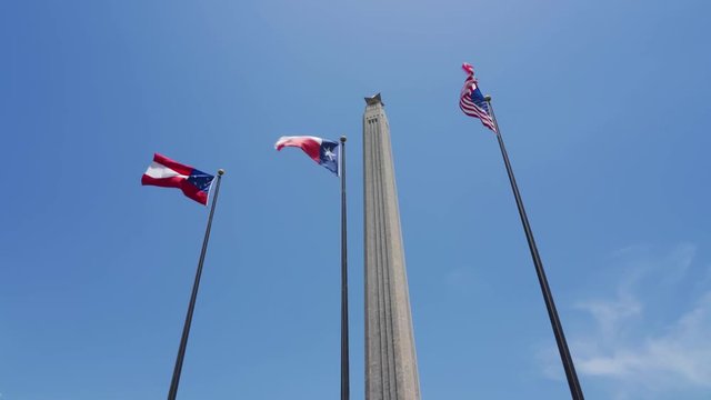 San Jacinto Monument in background of flags - Houston, Texas