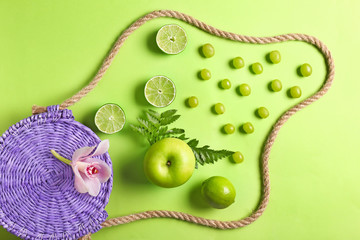 Beach bag and different fruits on color background