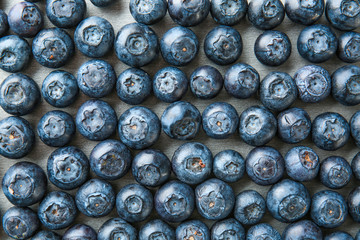 Many ripe blueberry on grey background