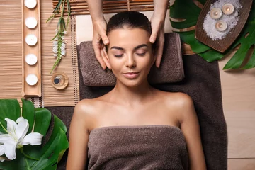 Fotobehang Beautiful young woman receiving massage in spa salon © Pixel-Shot