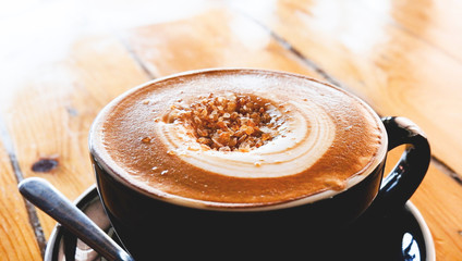 coffee cup on table / cappuccino cup with latte art and sugar on top