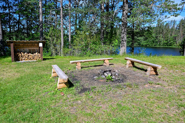 benches around a fire place in a Swedish forest