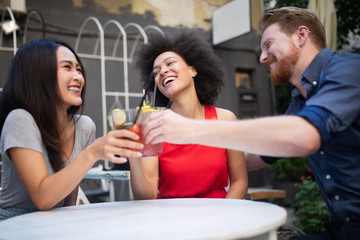 Young friends having a great time together. Group of people talking and smiling.