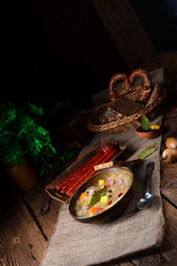 Obraz na płótnie Canvas rustic sauerkraut soup with bacon and sausage