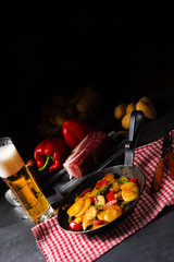 Fried potatoes with smoked bacon, green asparagus and paprika.