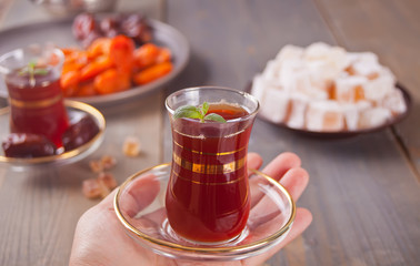 Turkish tea in traditional glass cups and turkish sweets