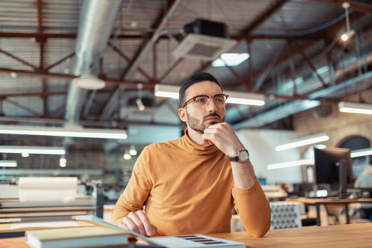 Writer feeling thoughtful while choosing cover for his book