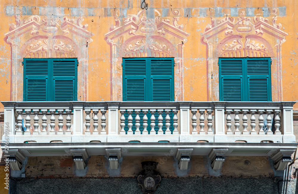 Poster close-up of the balcony of an old villa in the historical centre of rapallo with closed green shutte