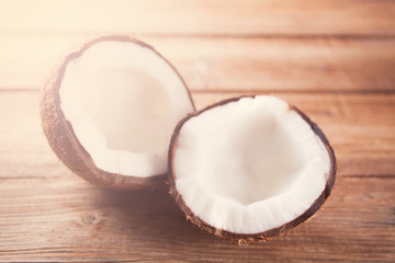 Coconut on the wooden background under tropical sun