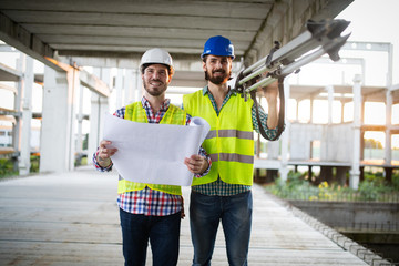 Construction engineer with foreman worker checking construction site