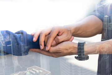 Double exposure of Businessman with client holding hands together for comfort and support work...