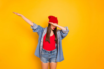 Portrait of cute teenager hide face raise hands isolated over yellow bright background