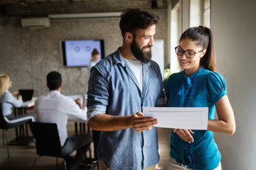 Group of business professionals having a meeting. Diverse group of designers smiling at the office.