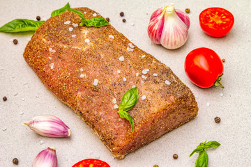 Raw pork loin with vegetables, species and herbs