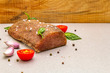Raw pork loin with vegetables, species and herbs