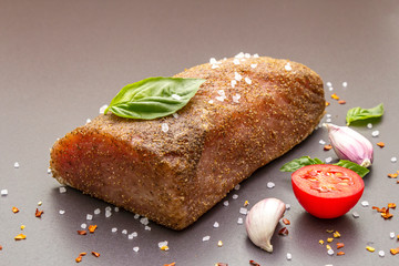 Raw pork loin with vegetables, species and herbs