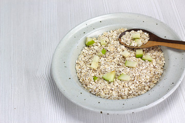 dish with oatmeal and pieces of apple and pear, Nutritious breakfast food healthy oatmeals