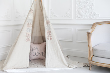 Cozy bright interior of the children's room with a wigwam.