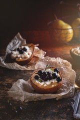 Baked pear with honey, cottage cheese and currants. Fresh homemade dessert. Food composition in a low key. Close-up, copy space.