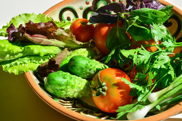  Raw vegetables on a clay plate