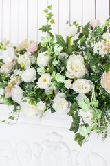 Decoration of the fireplace with flowers in a bright interior. close up. Soft focus.