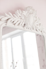 Vintage Baroque mirror with wood carvings in the Royal interior. Close up. Soft focus.
