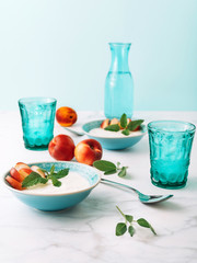 Healthy breakfast concept of natural greek yoghurt, fruit and water on marble table. Close-up.