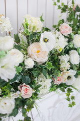 Decoration of the fireplace with flowers in a bright interior. close up. Soft focus.