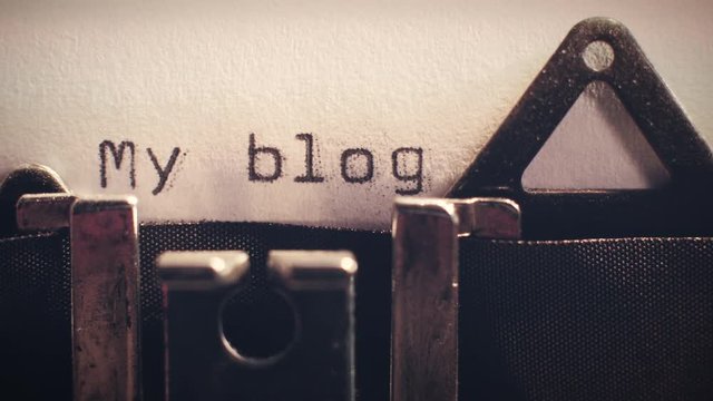 Vintage typewriter with a close-up of the word 'my blog' being typed.